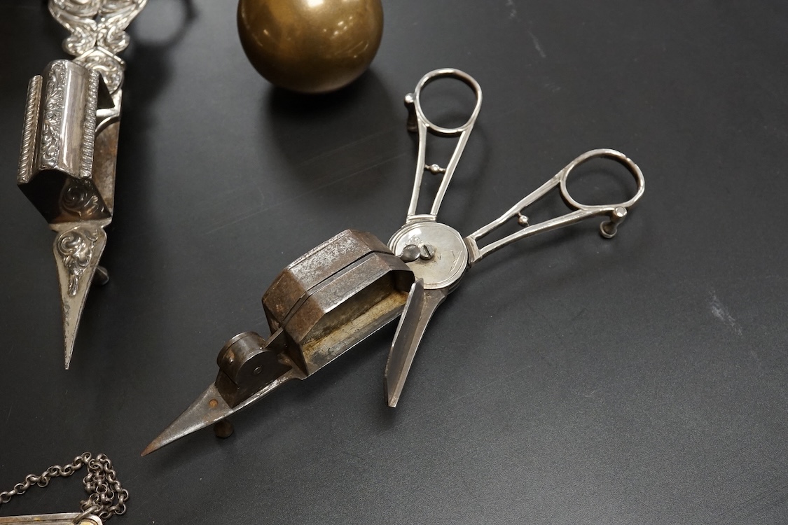 Four assorted pairs of 19th century plated candle snuffers, a large plated box, plated cream jug, ball and seven plated wine labels. Box 10cm high x 16.5cm wide.